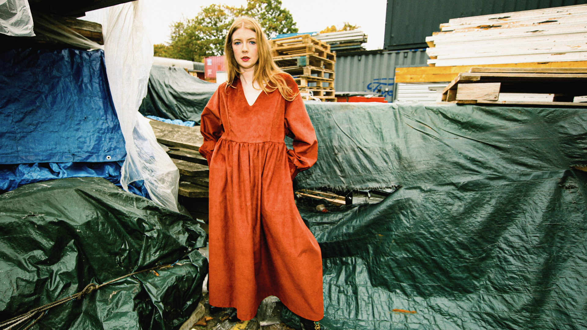 a woman wearing a red dress in the industrial estates