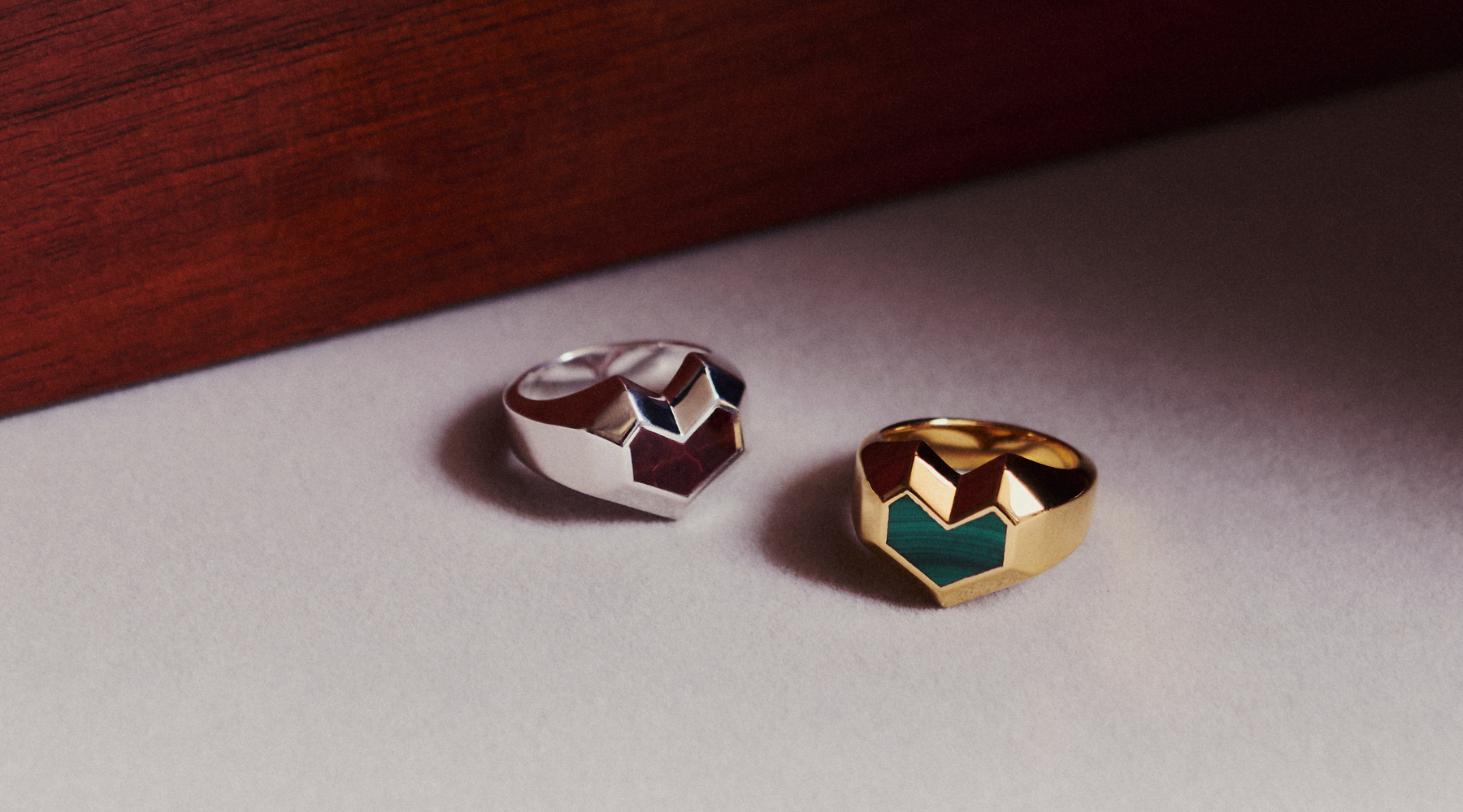 heart shape rings in gold with green stone and in silver with brown stone