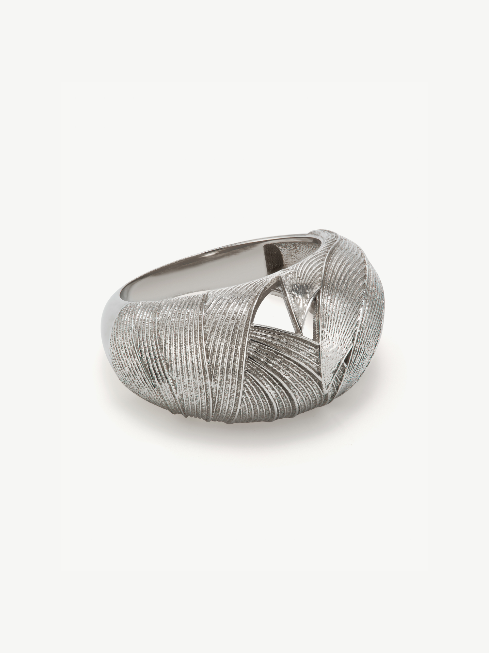Silver ring with textured design on a white background