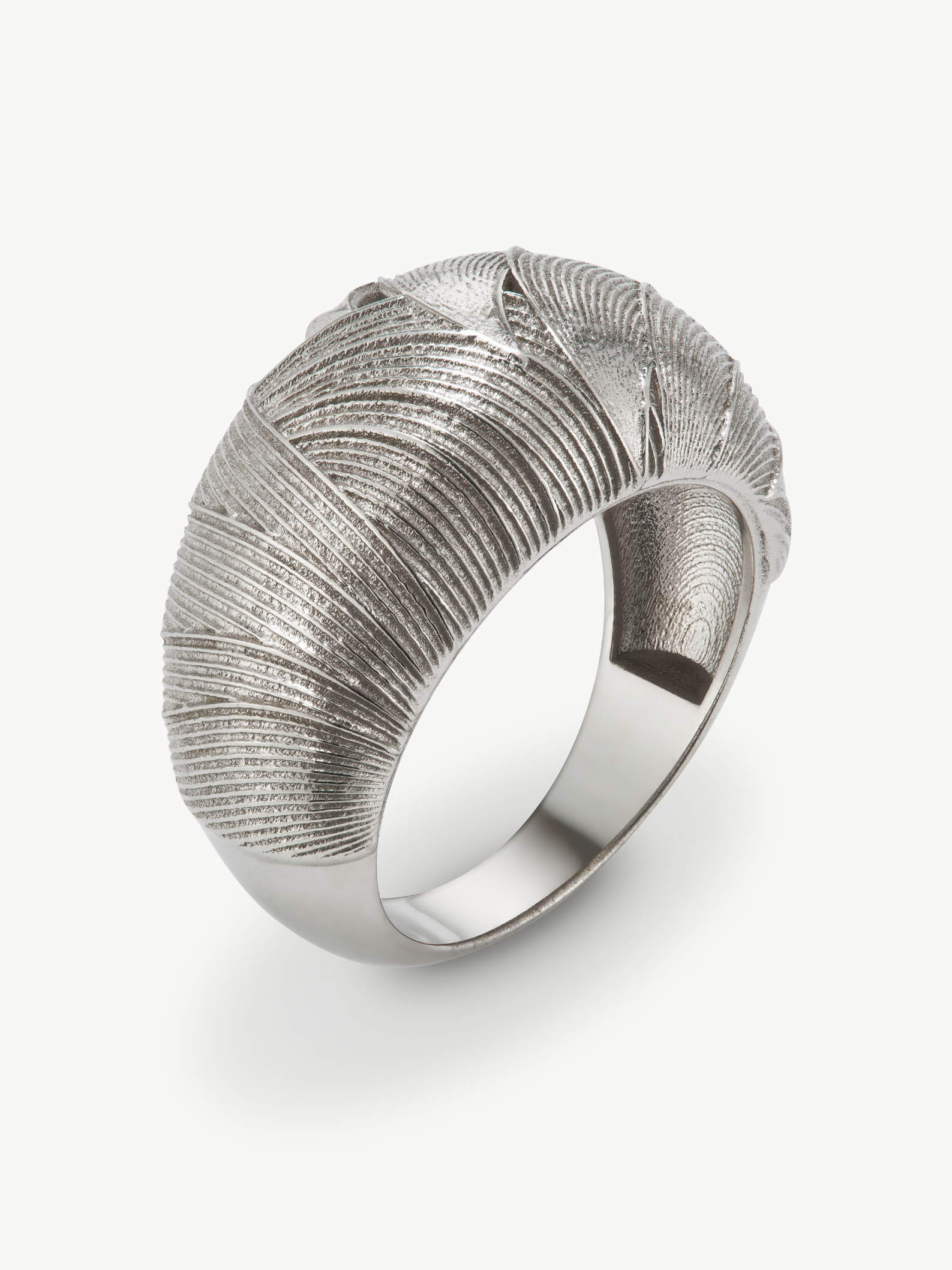 Silver ring with textured design on a white background