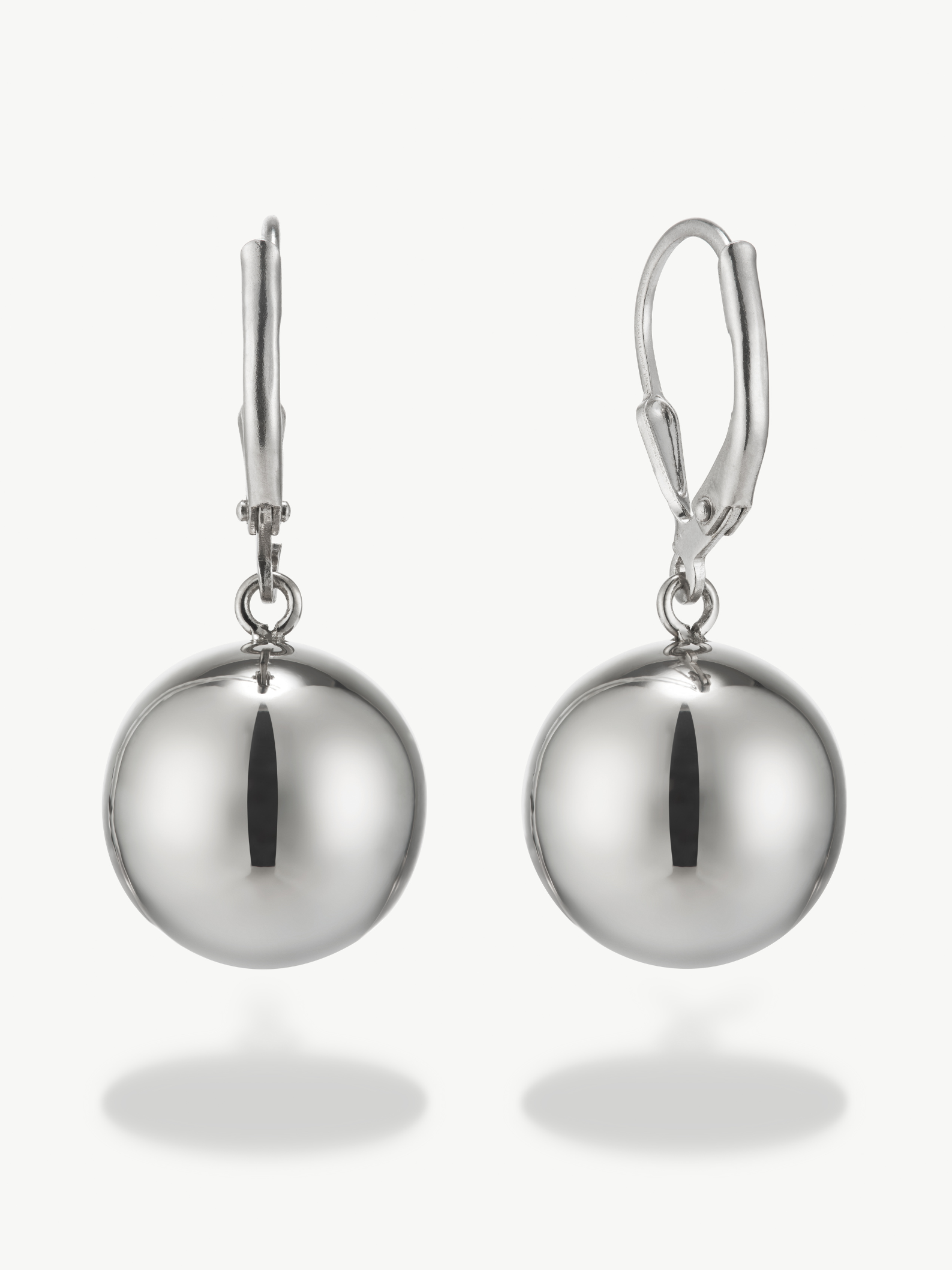 Pair of silver ball earrings on a white background