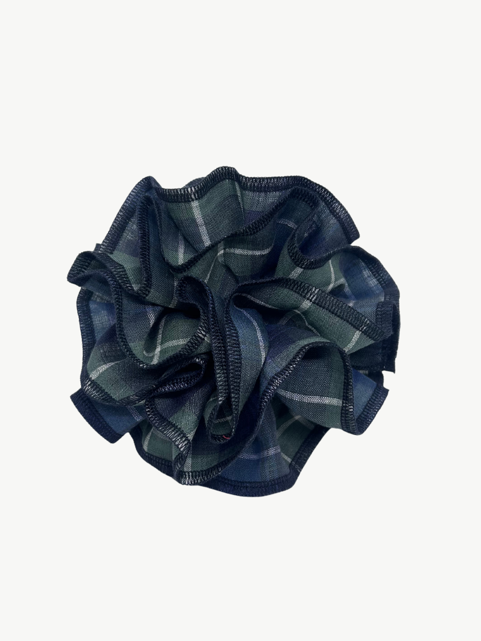 Plaid navy and green hair scrunchies in a shape of a flower on a white background