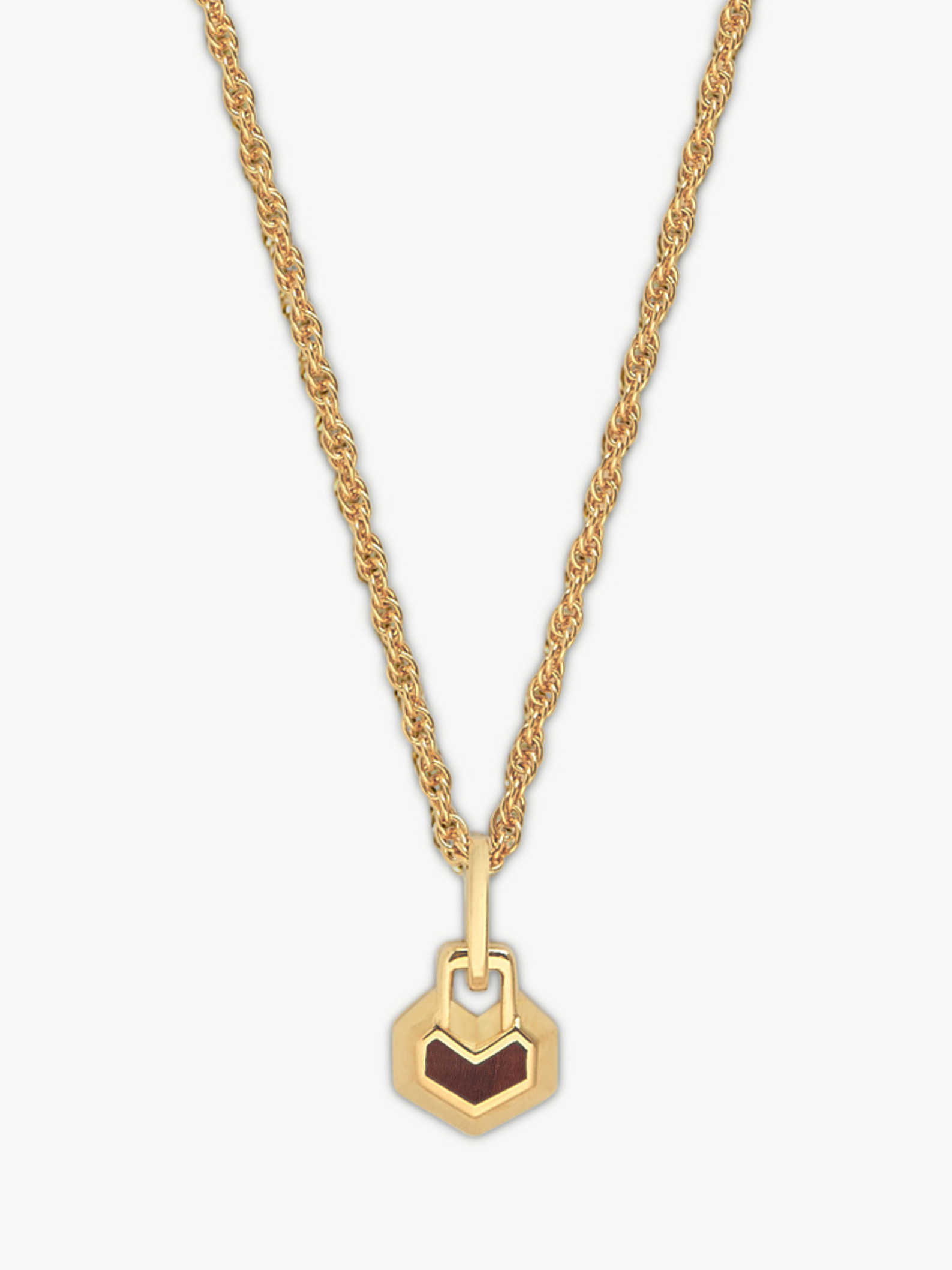 Gold necklace with a heart pendant on a white background