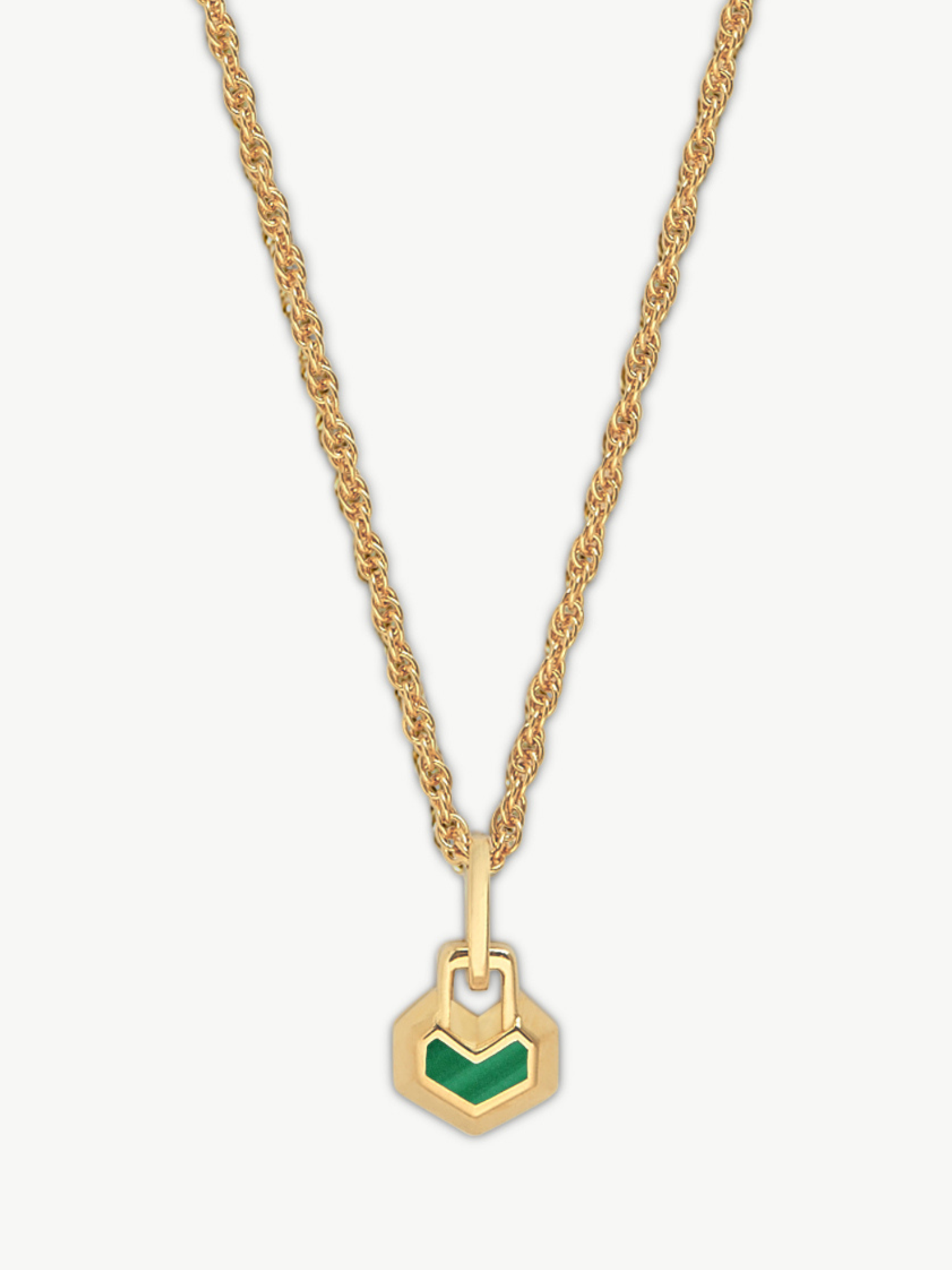 Gold necklace with a green hexagonal pendant on a white background