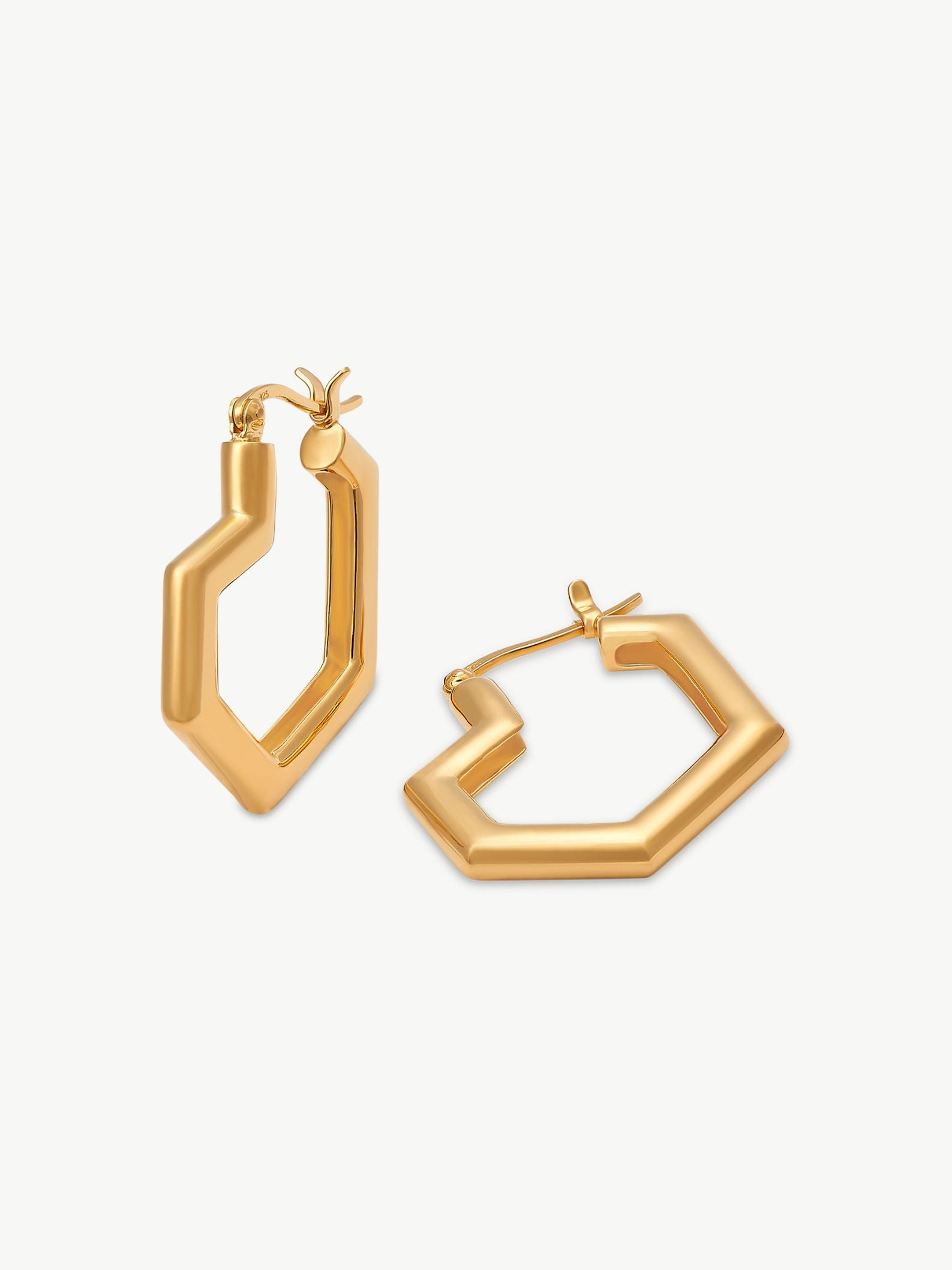 Gold heart hoop earrings on a white background