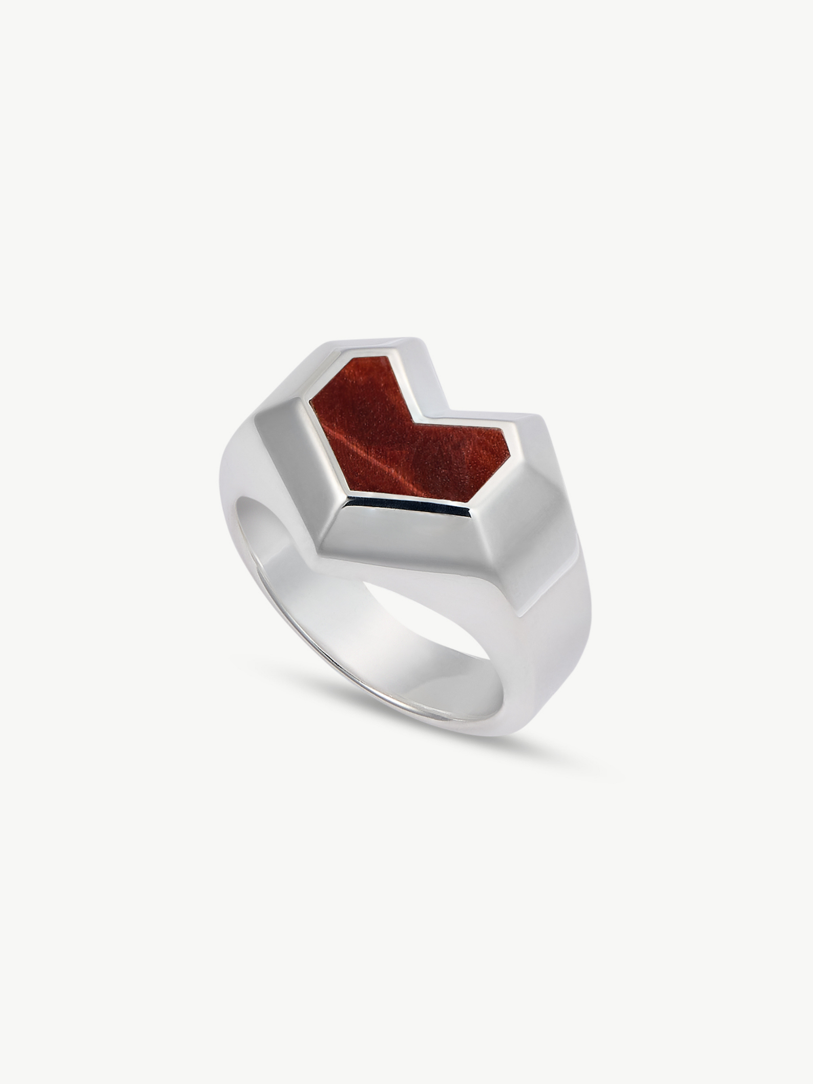 Silver ring with a red stone on a white background