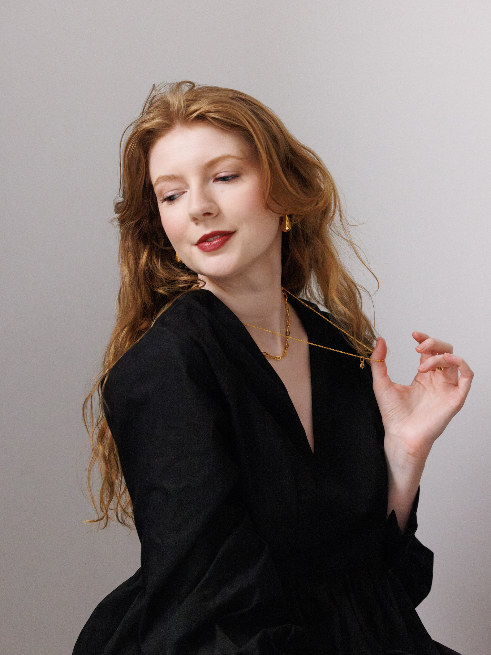 Woman wearing a black outfit with a plain background