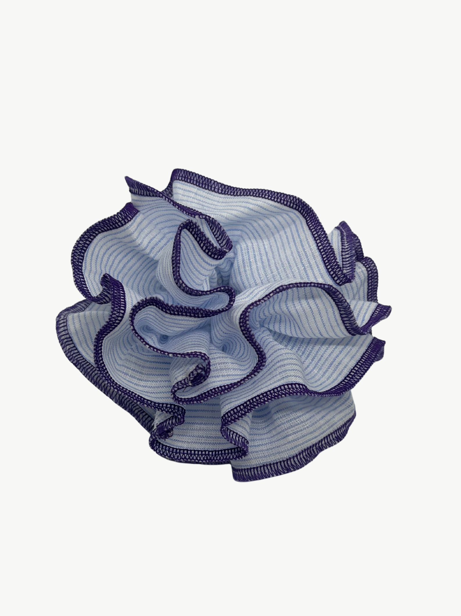 Blue ruffled hair scrunchie with purple edges on a white background