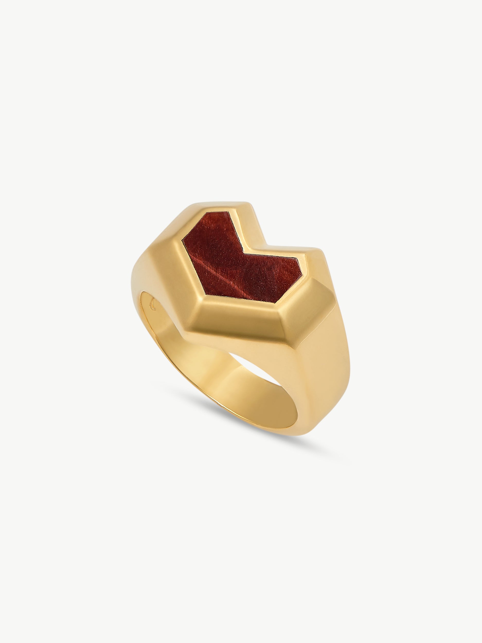 Gold ring with a red stone on a white background