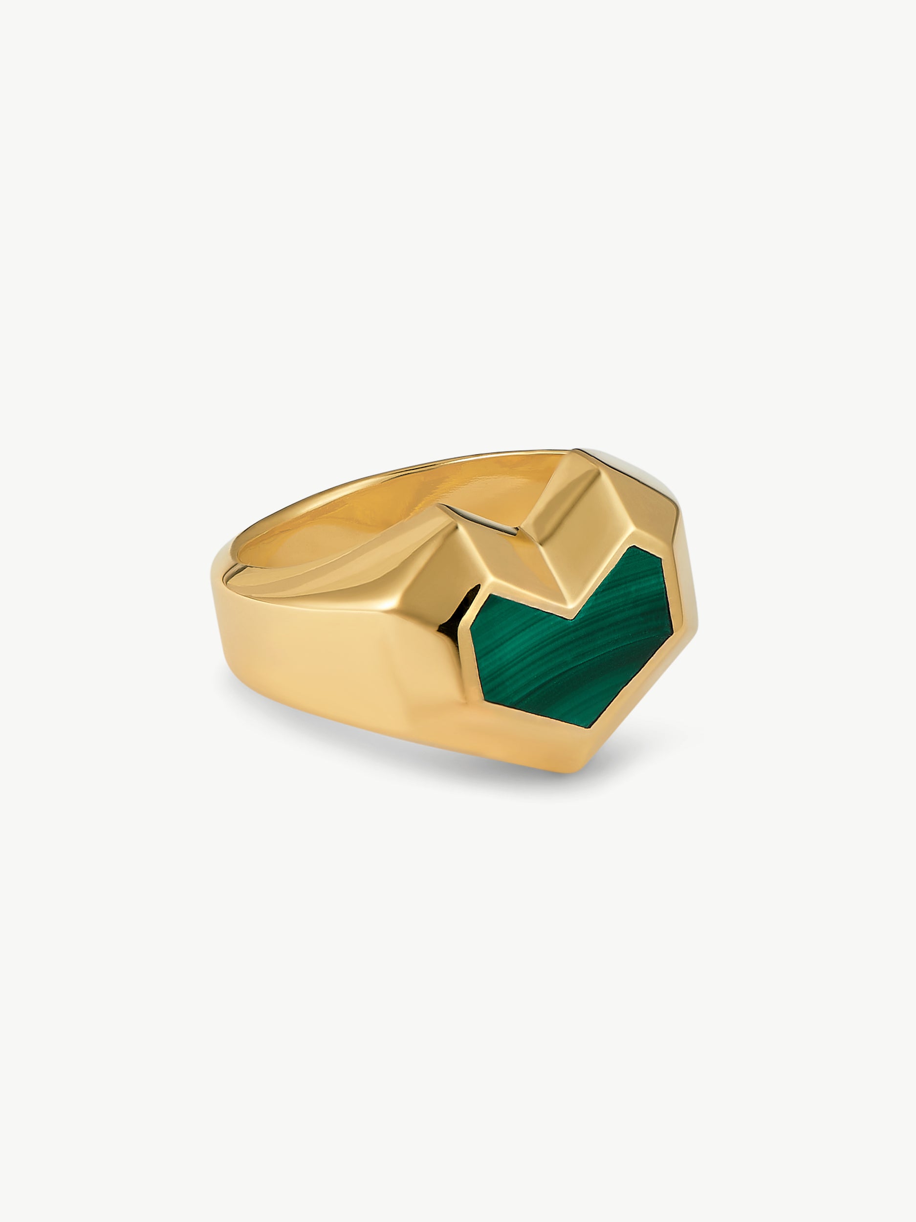 Gold ring with a green gemstone on a white background