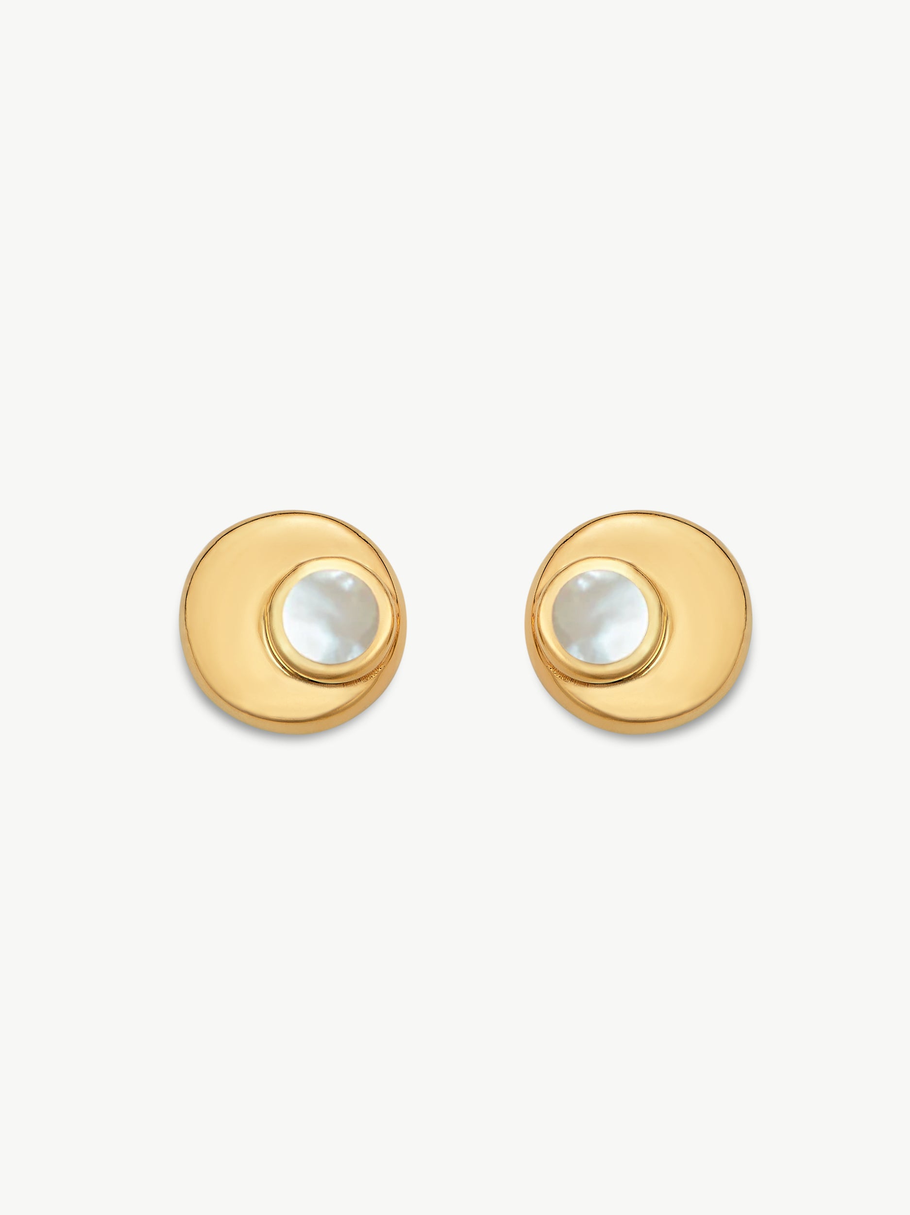 Gold earrings with a central gemstone on a white background