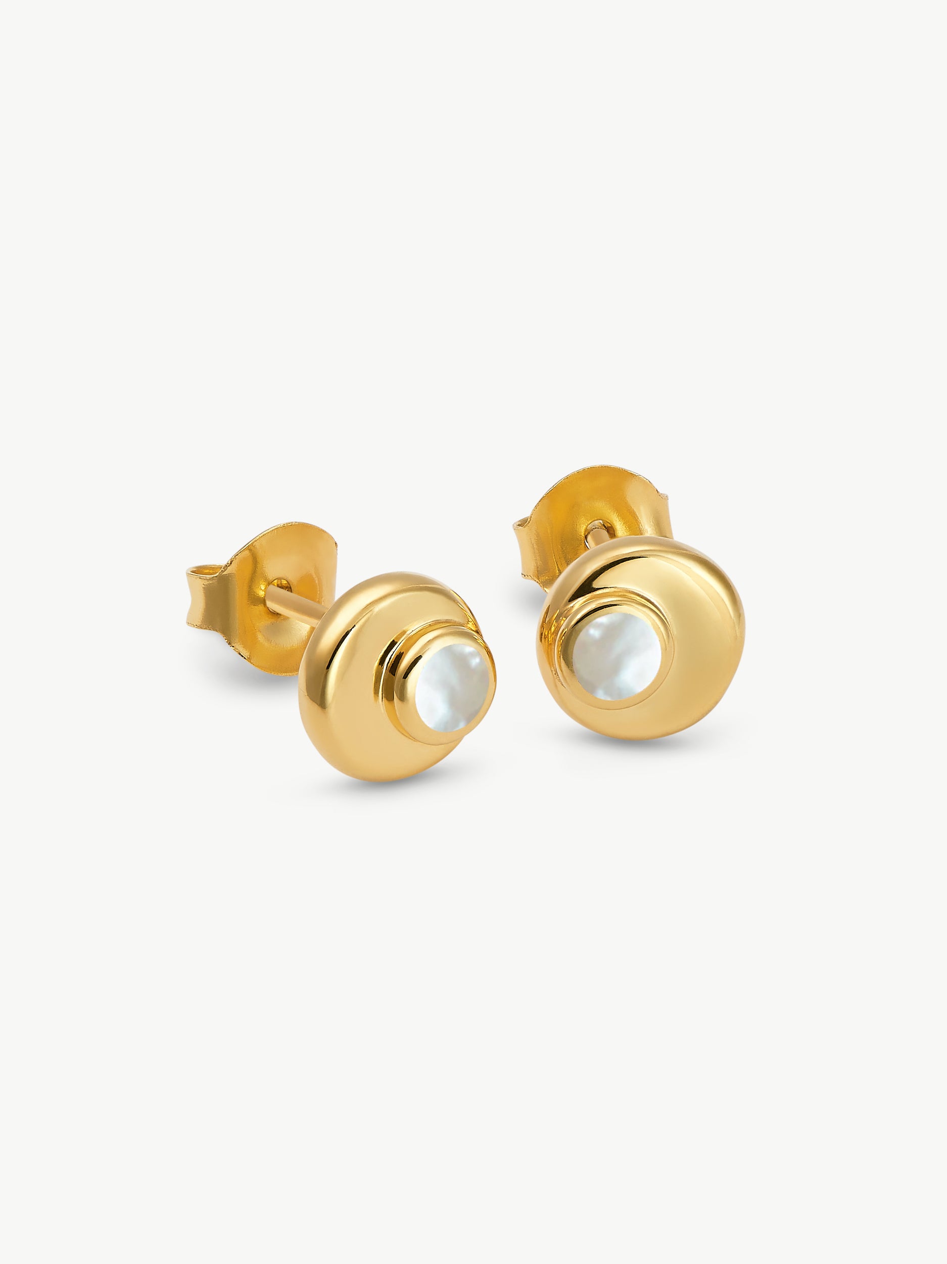 Gold stud earrings with a central gemstone on a white background