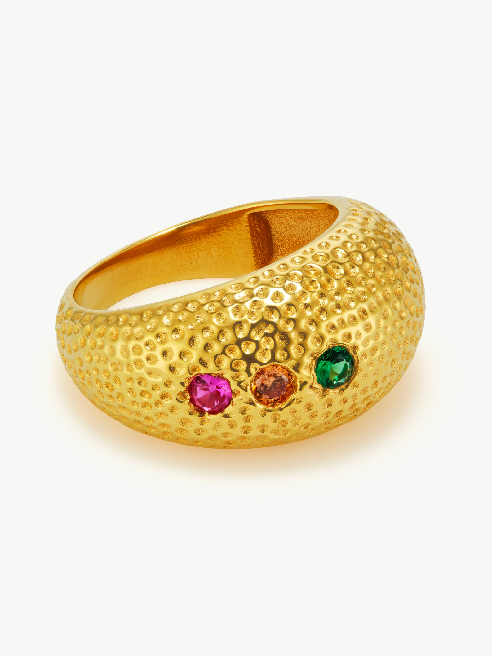 Gold ring with colorful gemstones on a white background