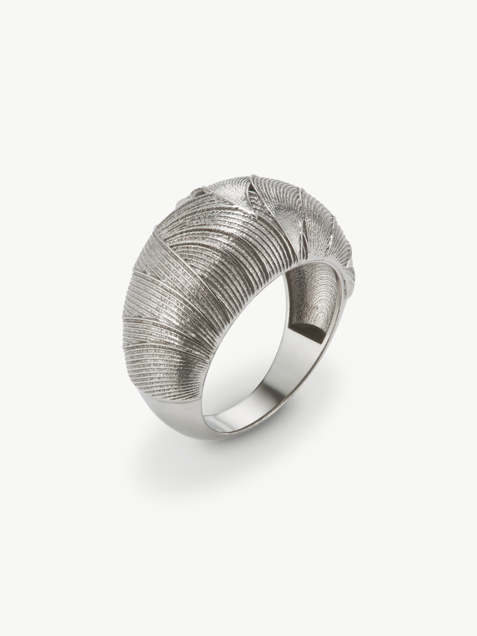 Silver ring with textured design on a white background