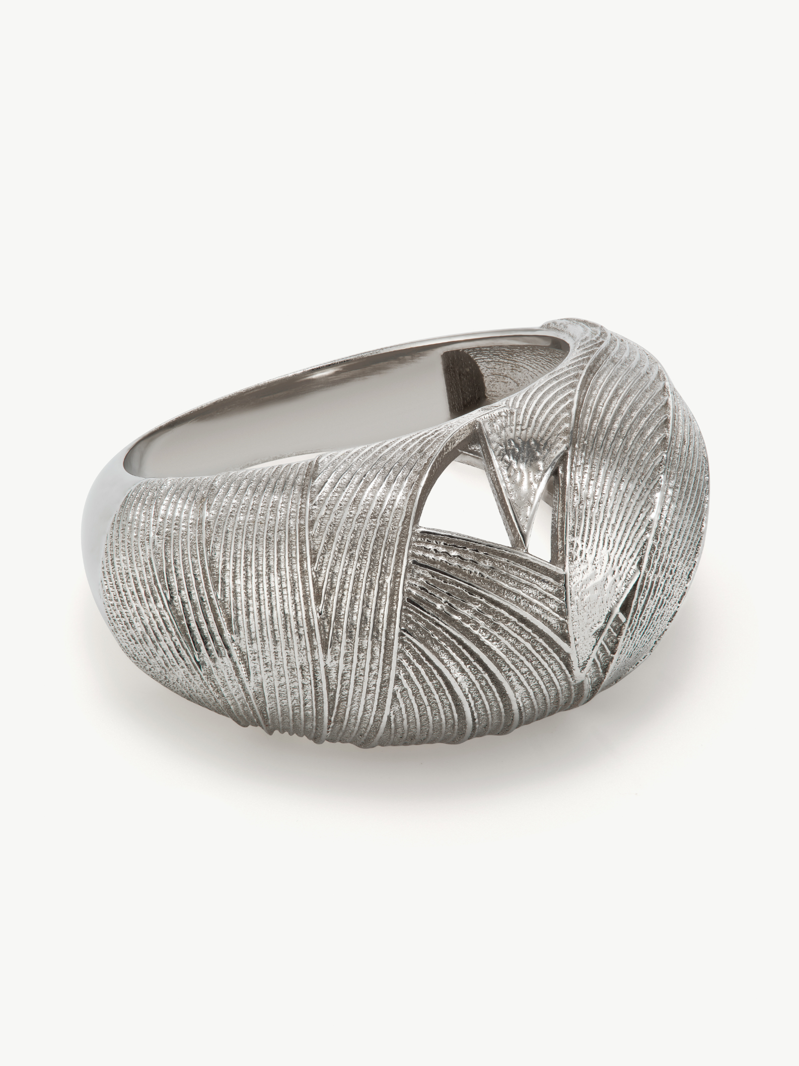 Silver ring with textured design on a white background
