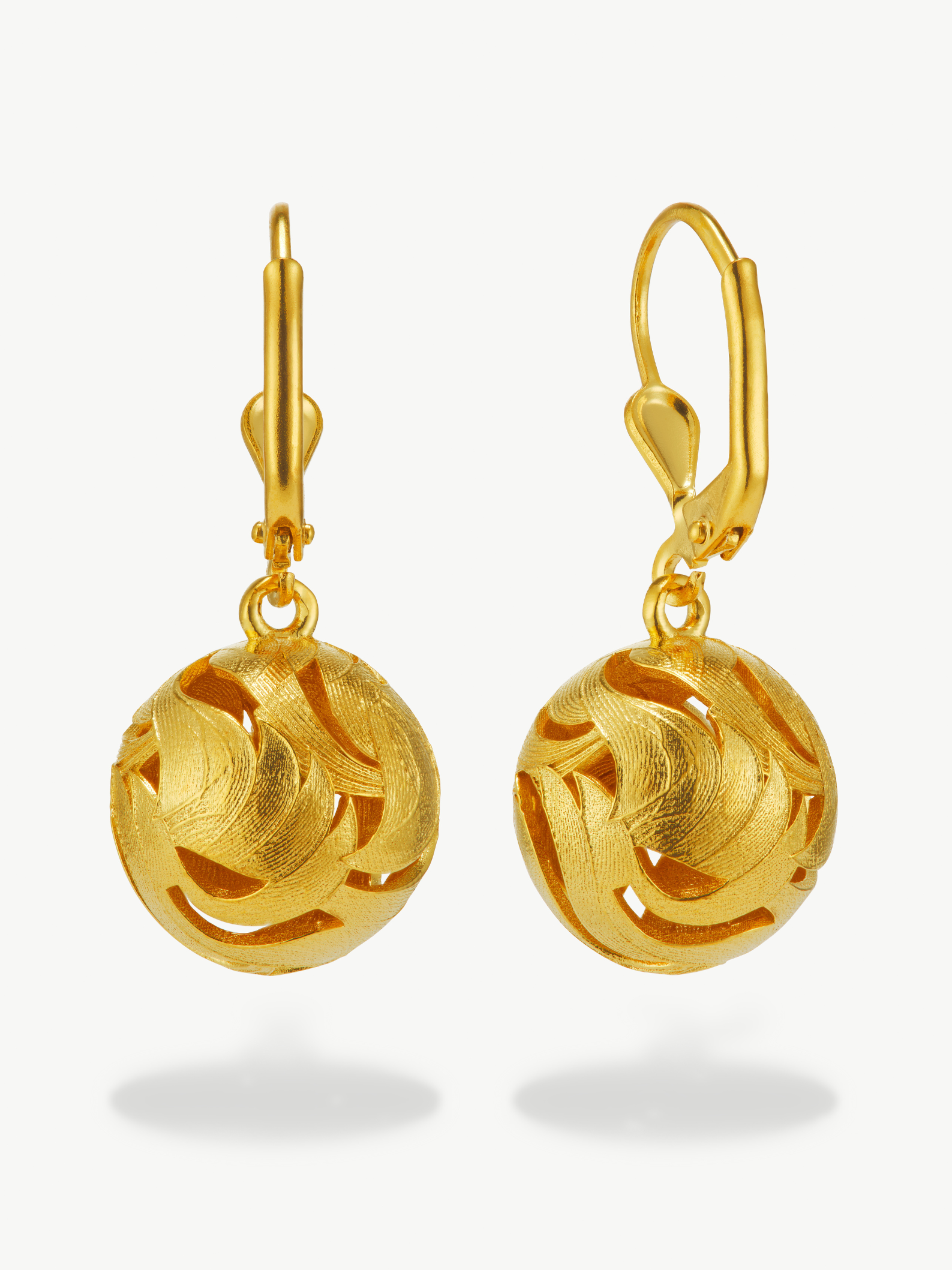 Pair of gold earrings on a white background