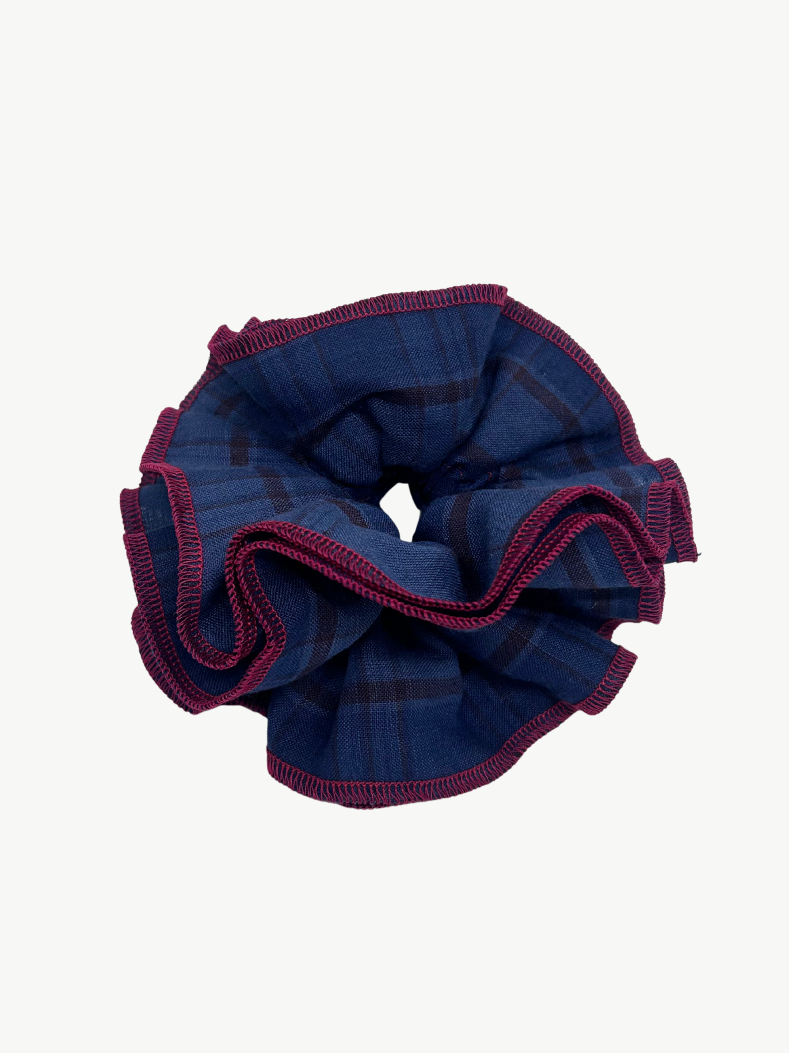 Blue scrunchie with red trim on a white background