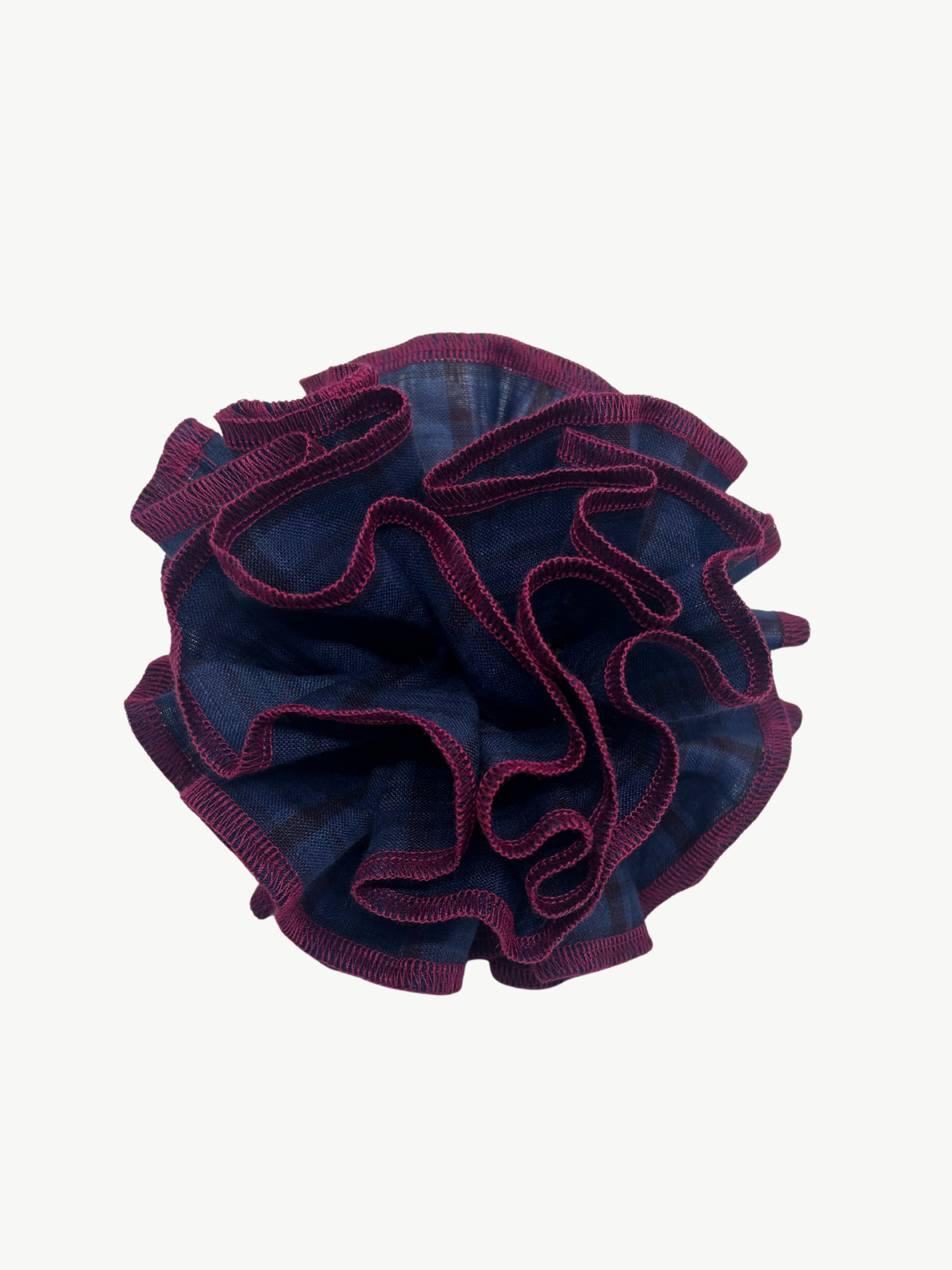 Navy blue check scrunchie with red edges on a white background