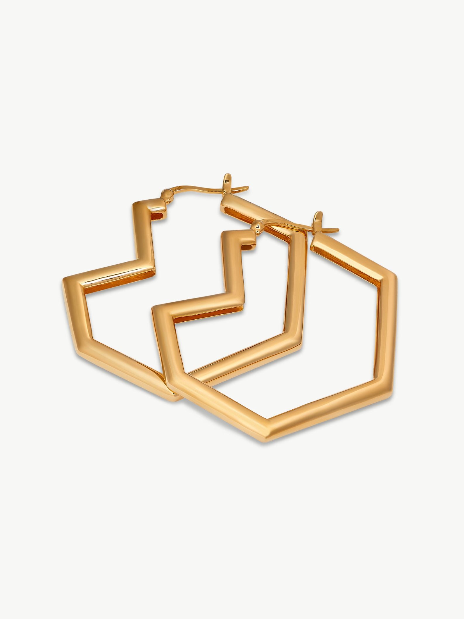 Gold heart hoop earrings on a white background