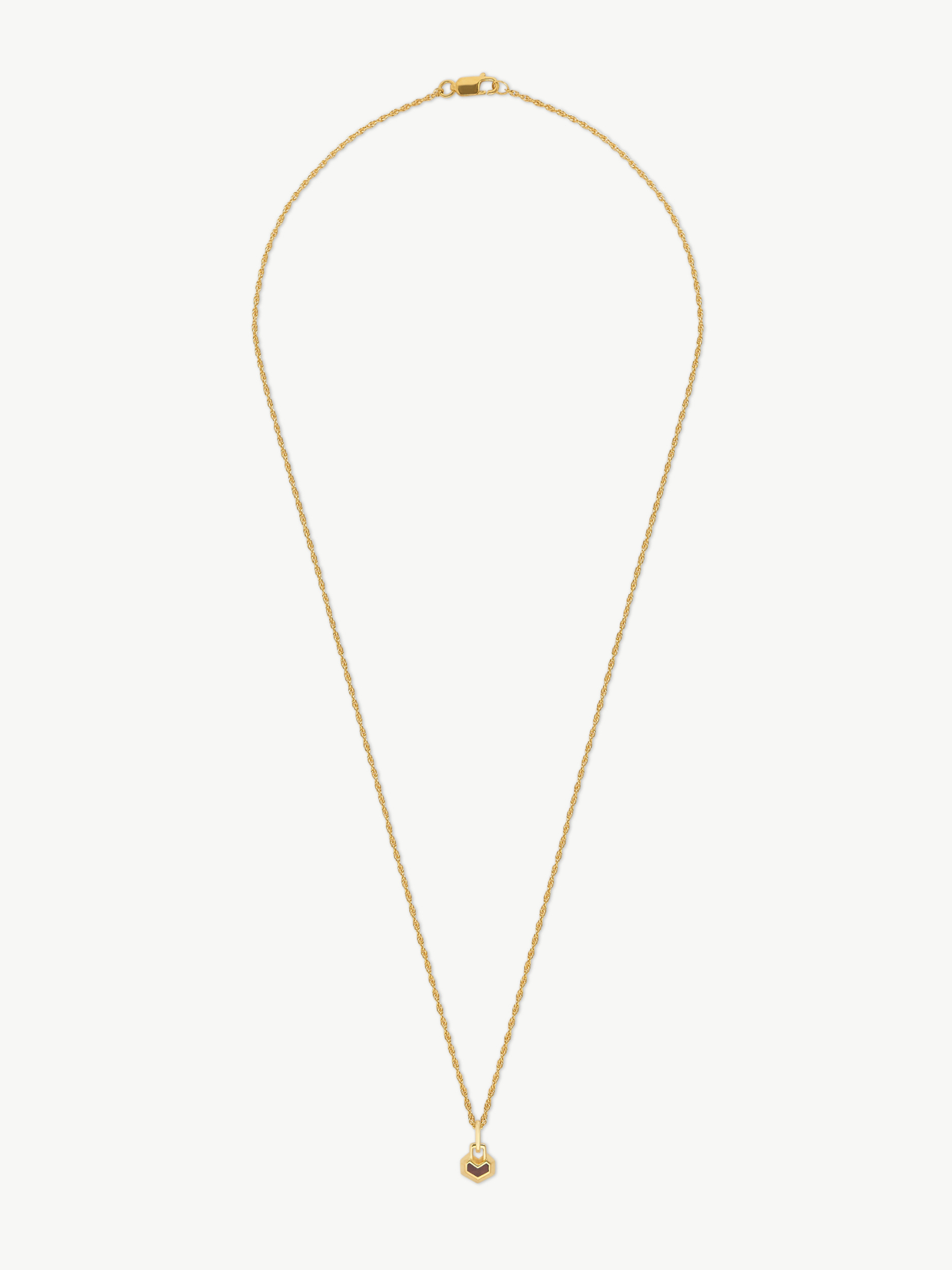 Gold necklace with a small round heart pendant on a white background