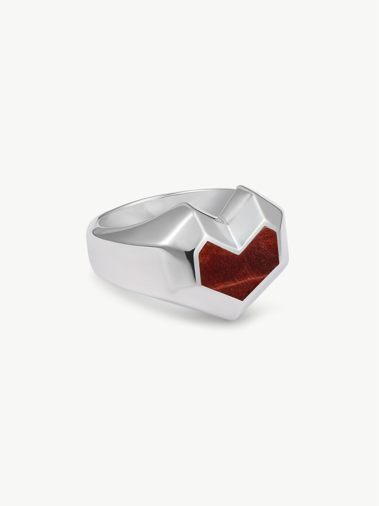 Silver ring with a red stone on a white background