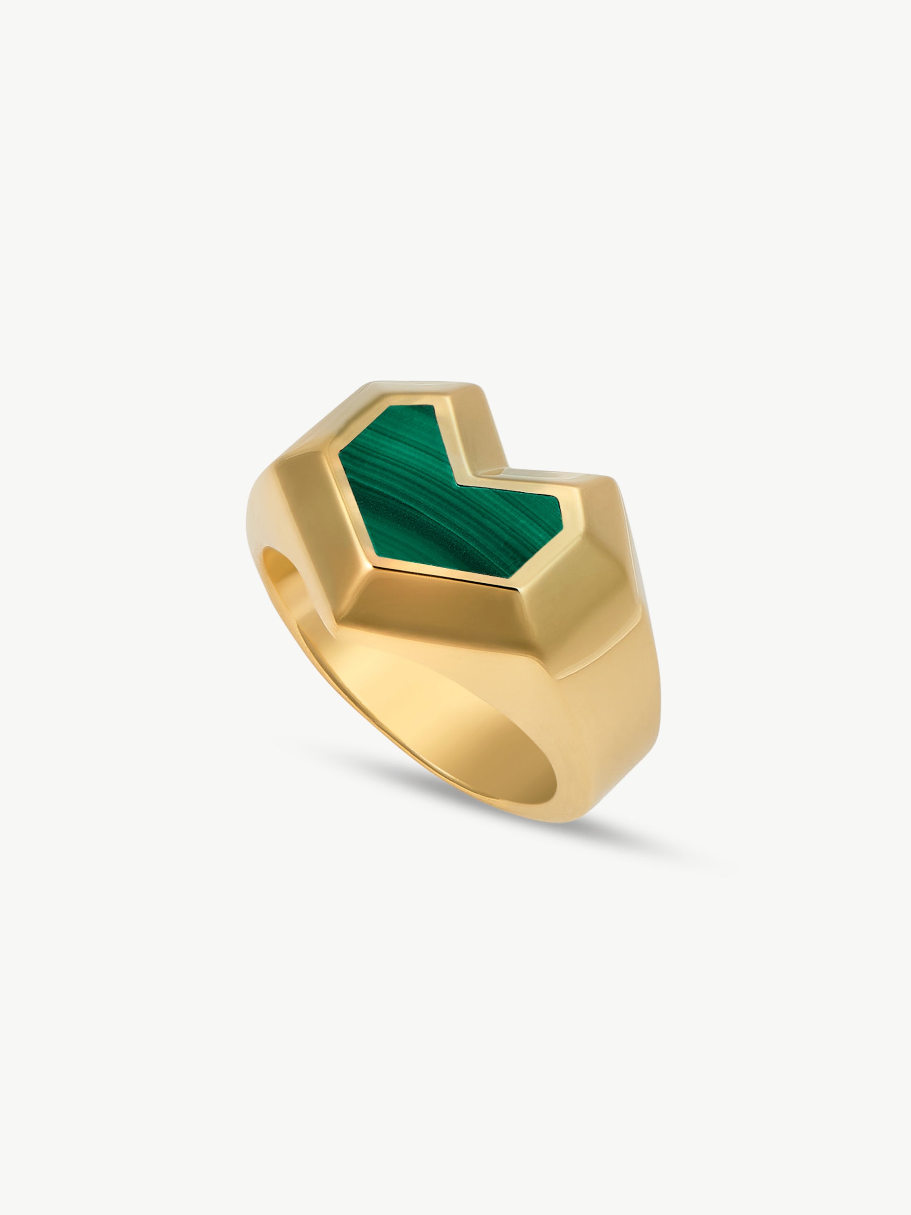Gold ring with a green stone on a white background