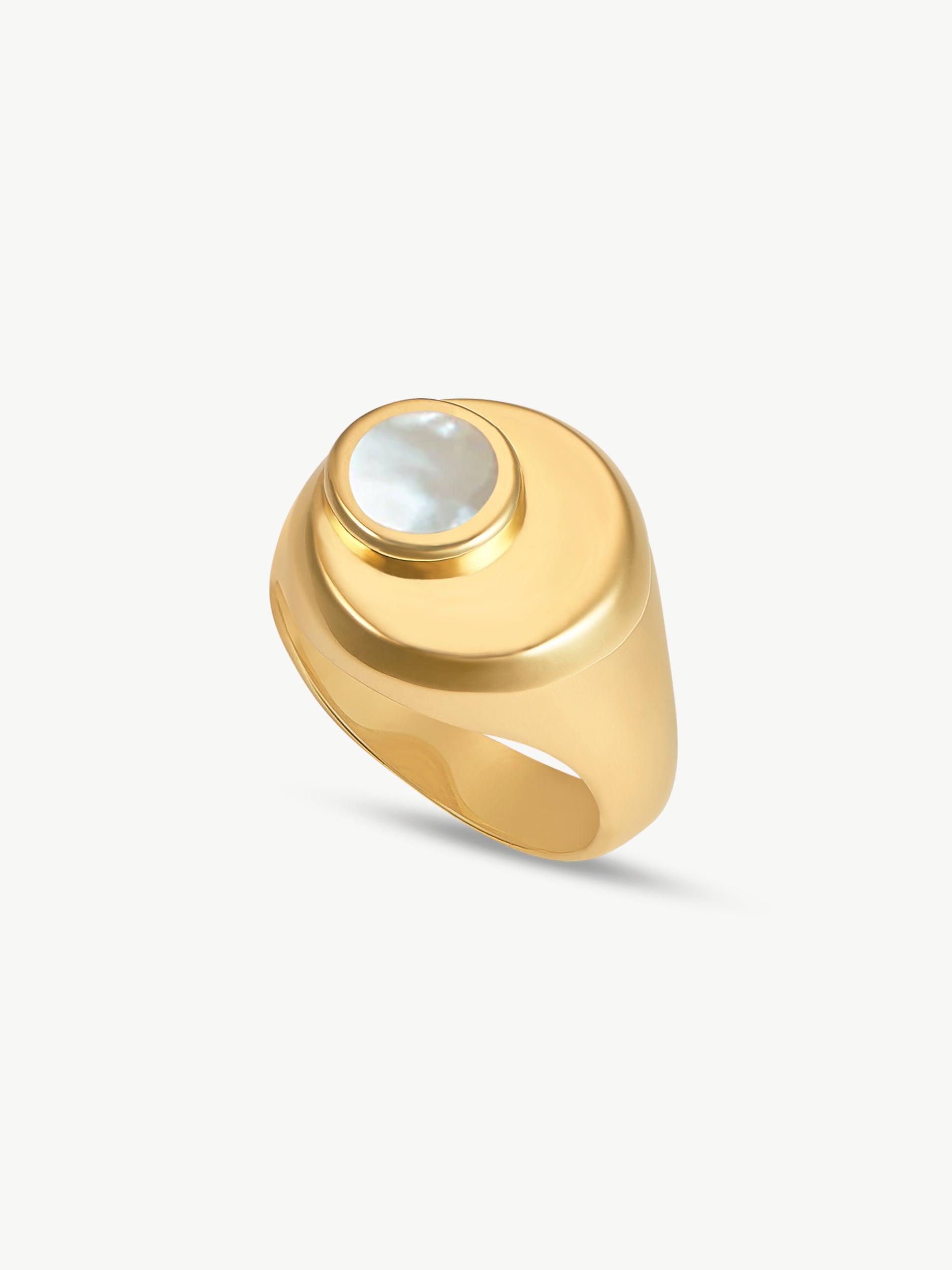 Gold ring with a central gemstone on a light gray background