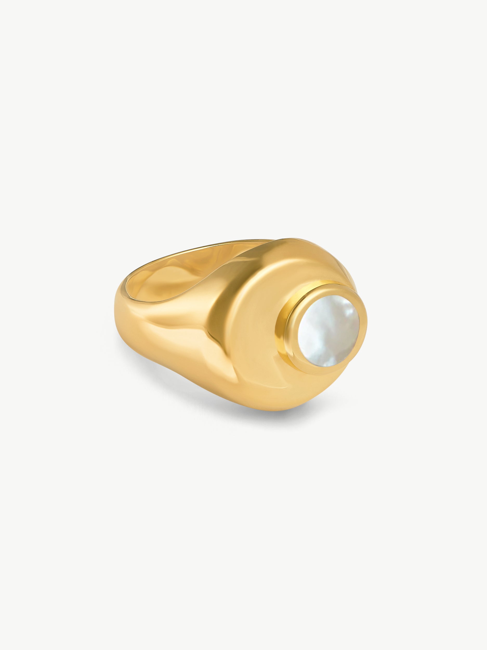 Gold ring with a central gemstone on a white background